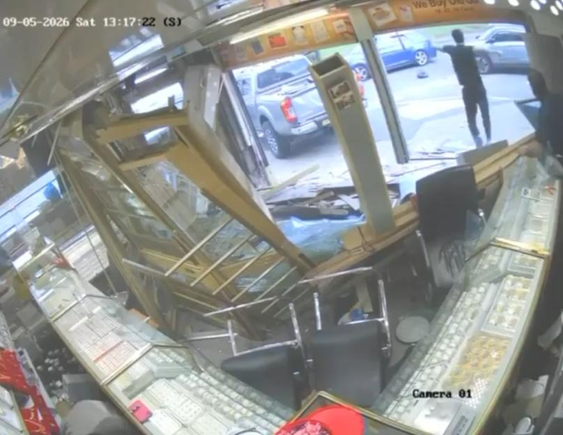 Security camera footage of a 4x4 pickup truck smashing through the glass storefront of a jewelry store.