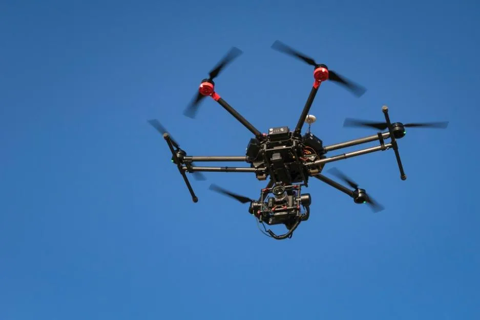 Professional Drone Hovering against the Blue Sky