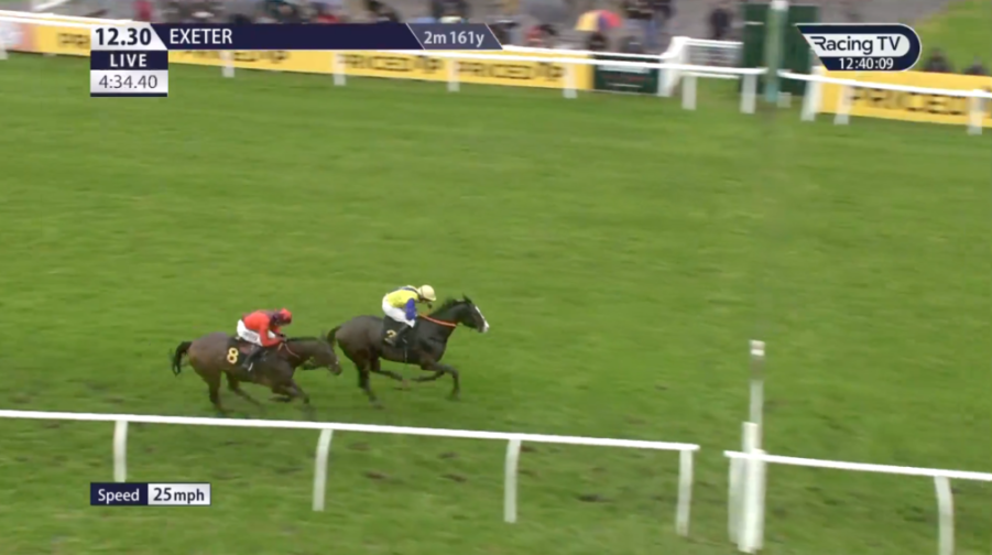 Two horses and jockeys race on a green track, with race information overlays.