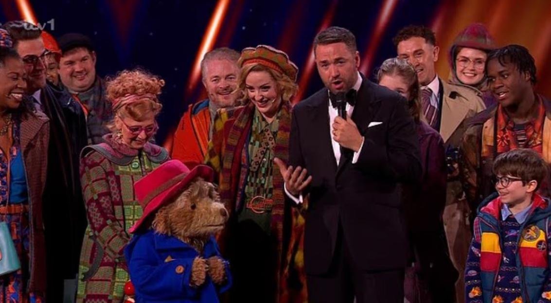 Jason Manford on stage at the Royal Variety Show, with Paddington Bear and cast members.