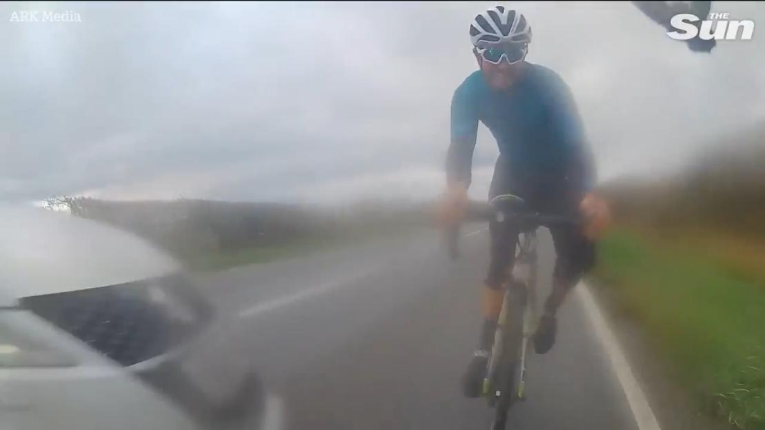 Close Call: Cyclist Darts Away as Car Skids and Crashes, Flipping Over in a Heart-Pounding Moment