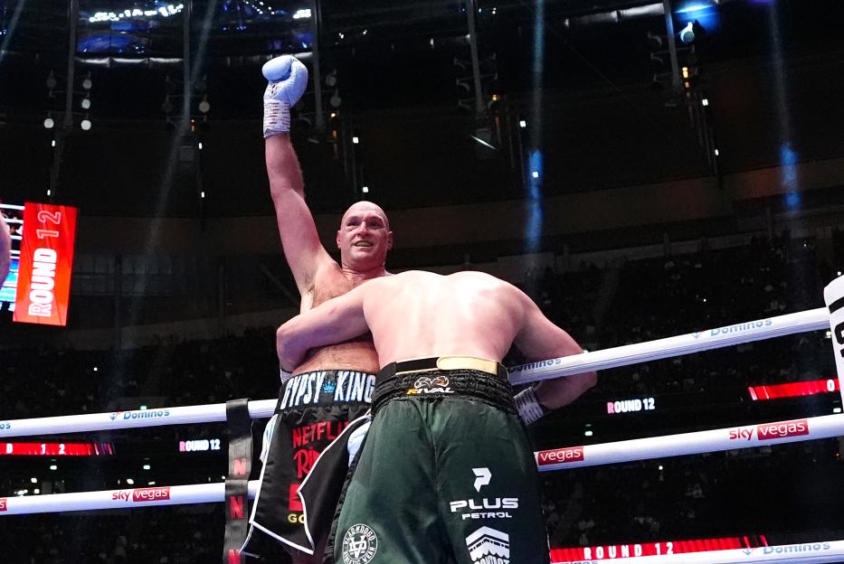 Tyson Fury celebrates his victory against Arslanbek Makhmudov in the boxing ring.