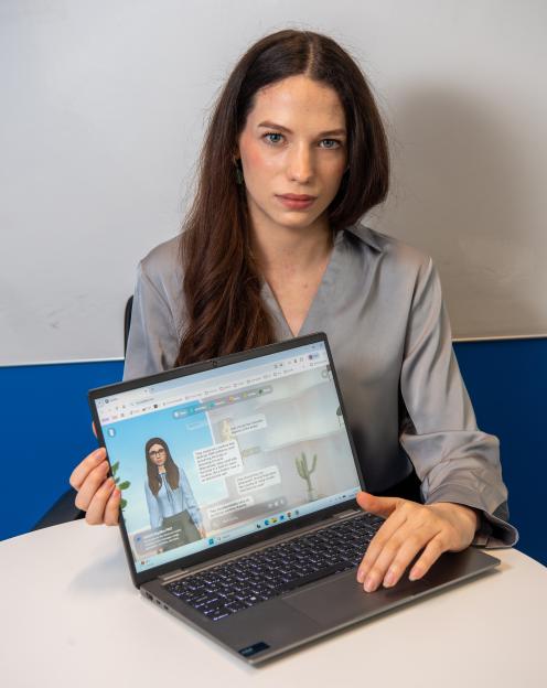 Emily Davies displaying a laptop with a Replika AI chatbot responding to questions about disposing of a body.