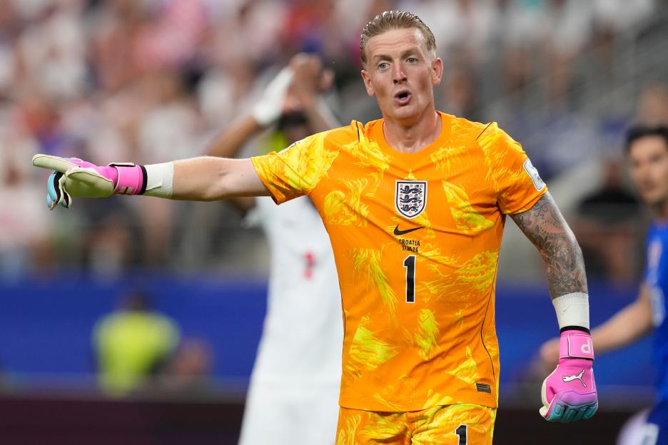 England goalkeeper Jordan Pickford reacts during a soccer match.