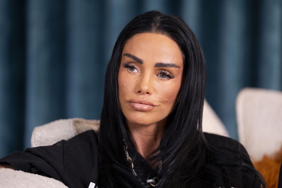 Katie Price looks to her right as she sits in a chair.