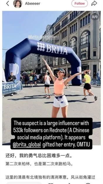 A screenshot of a social media post showing a runner posing in front of a large blue Brita arch on a city street, with superimposed text stating that the runner is a large influencer whose entry was gifted.