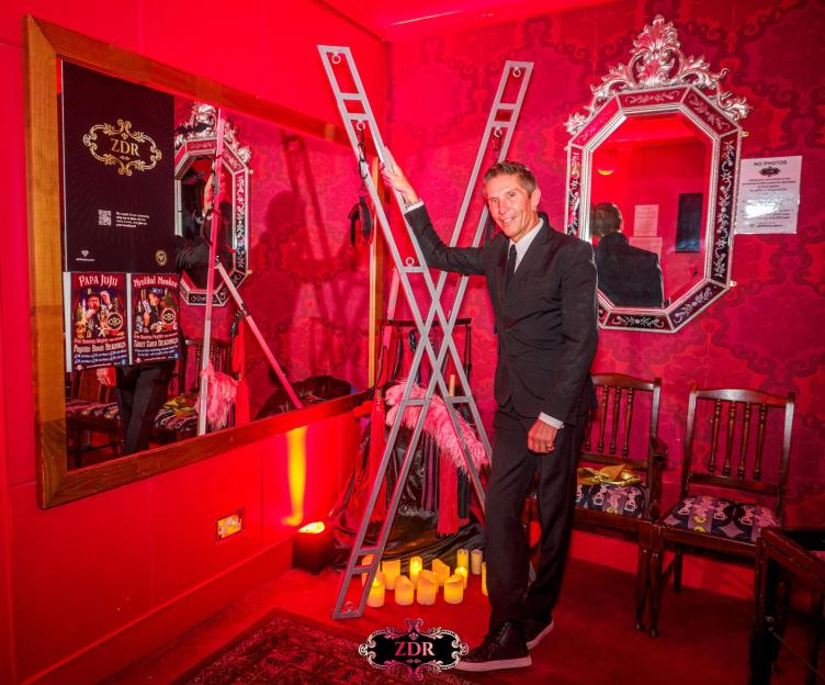 Tim posing with a kinky cross.