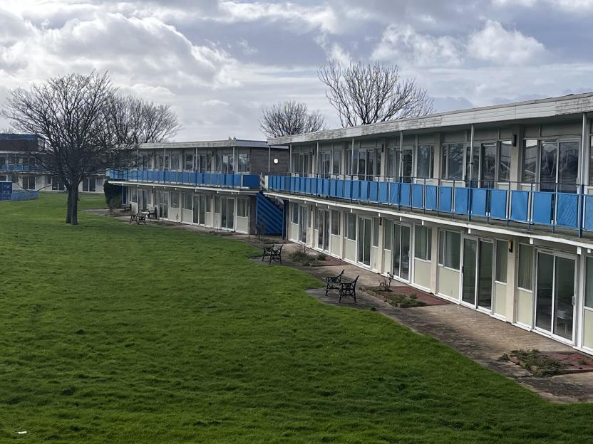 Former Pontins holiday park in Prestatyn with multiple units and a grassy area.