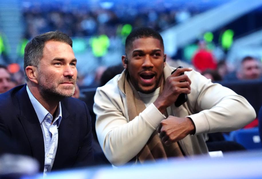 Eddie Hearn and Anthony Joshua in the stands at Tottenham Hotspur Stadium.