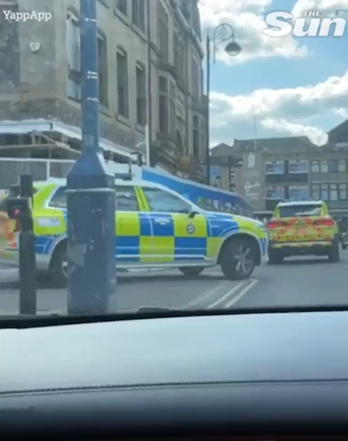Two police vehicles on a city street.