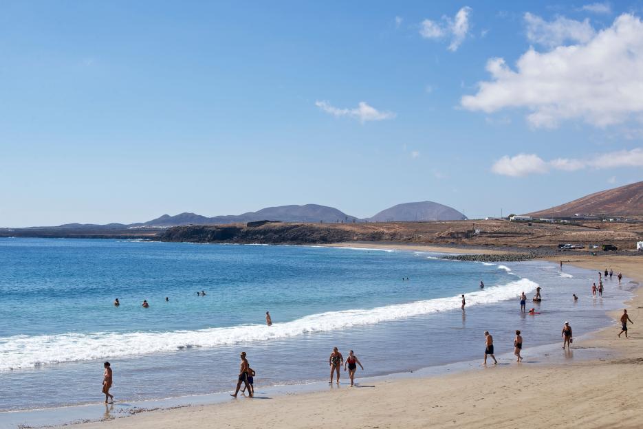 Bathers and sunbathers on Playa la Garita, Arrieta, Lanzarote, Spain.