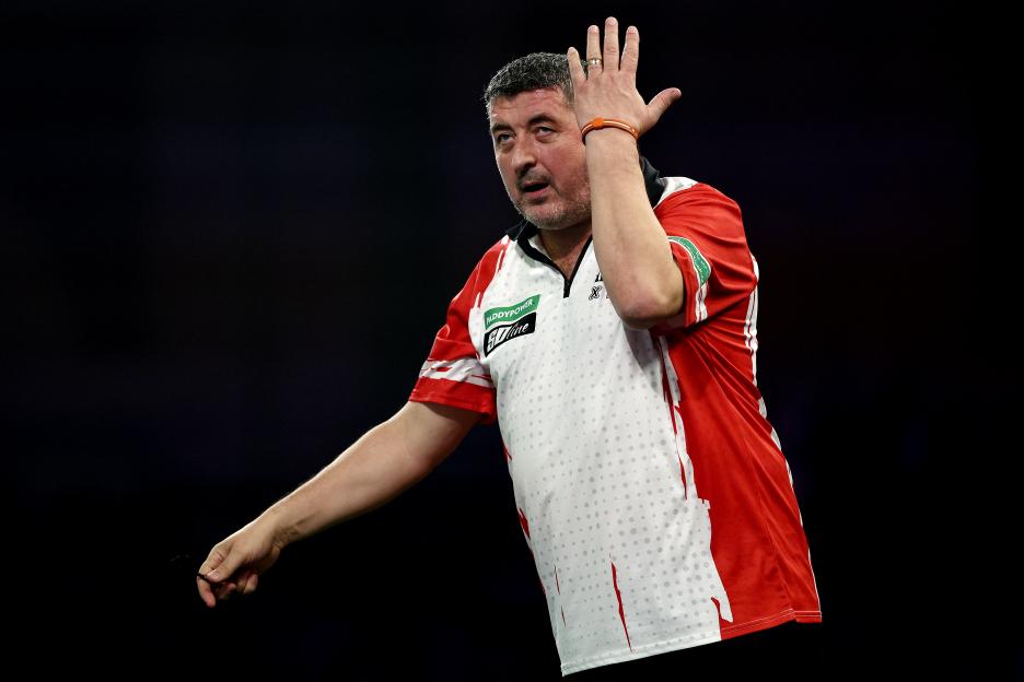 Mensur Suljovic reacting during the World Darts Championship.