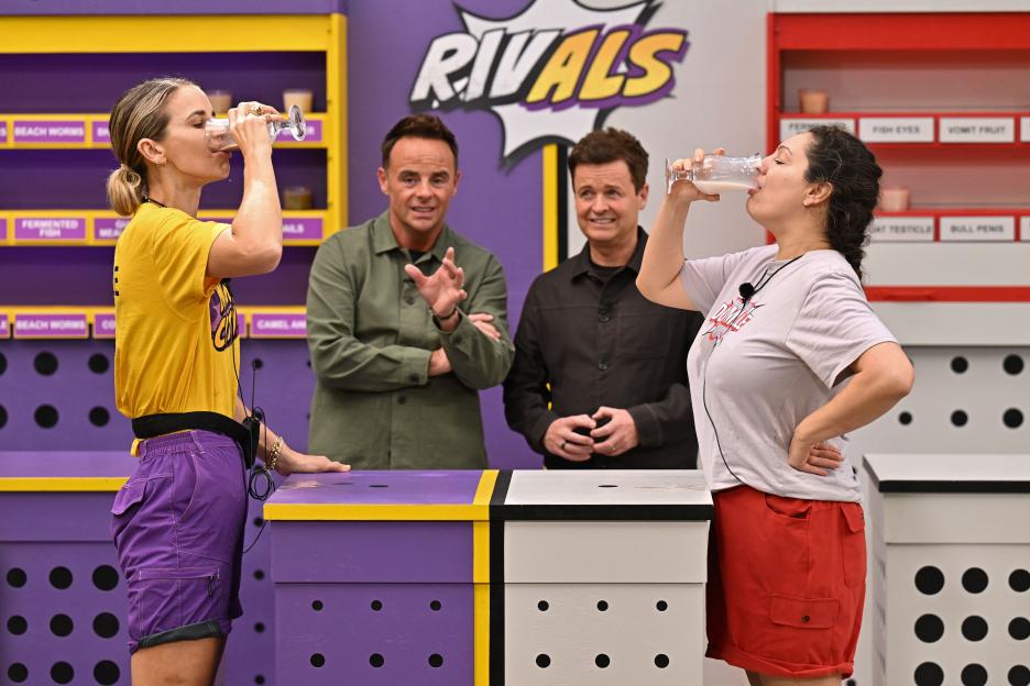 Vogue Williams and Kelly Brook drinking from glasses during a "Cocktails of Cruelty" bushtucker trial on "I'm a Celebrity... Get Me Out of Here!"