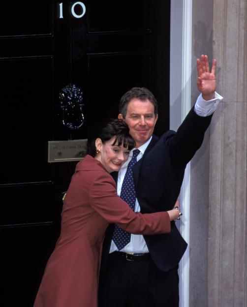 Newly elected British Labour Prime Minister Tony Blair waving with his wife Cherie on the steps of Number 10 Downing Street.