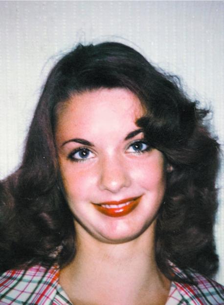 Close-up of Sarah Burge at age 14, with dark wavy hair and red lipstick.