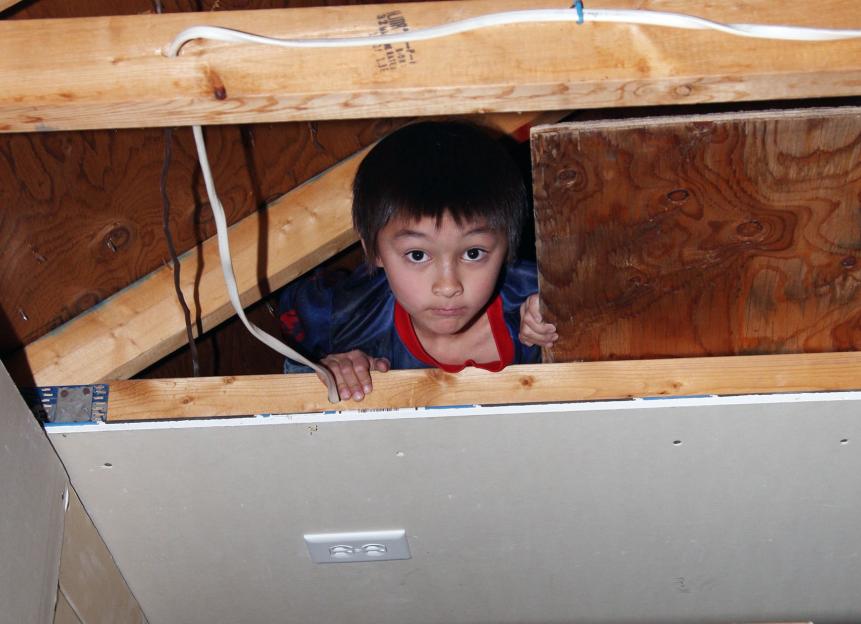 Boy hiding in attic.