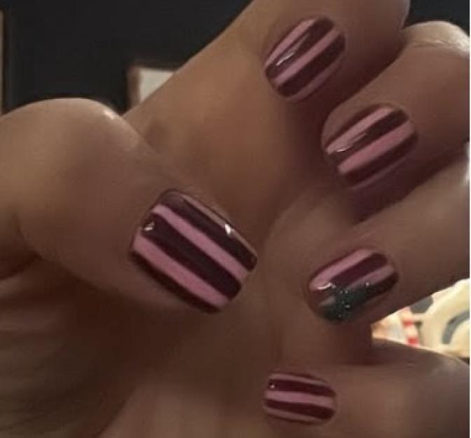 Manicured nails with pink and dark red stripes.