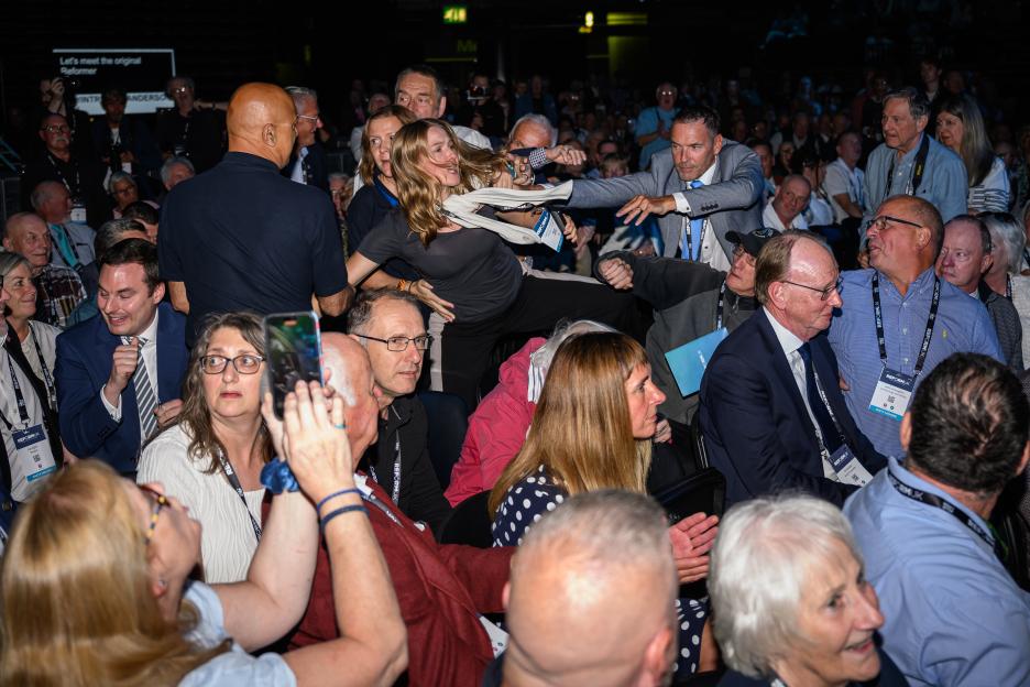 A protester being removed from the main hall during the Reform UK party conference.