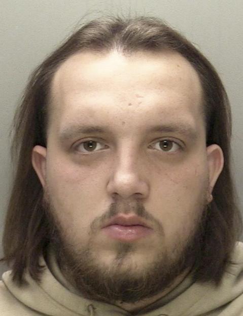 Mugshot of Casiim Montgomery with long dark hair, a mustache, and a beard.