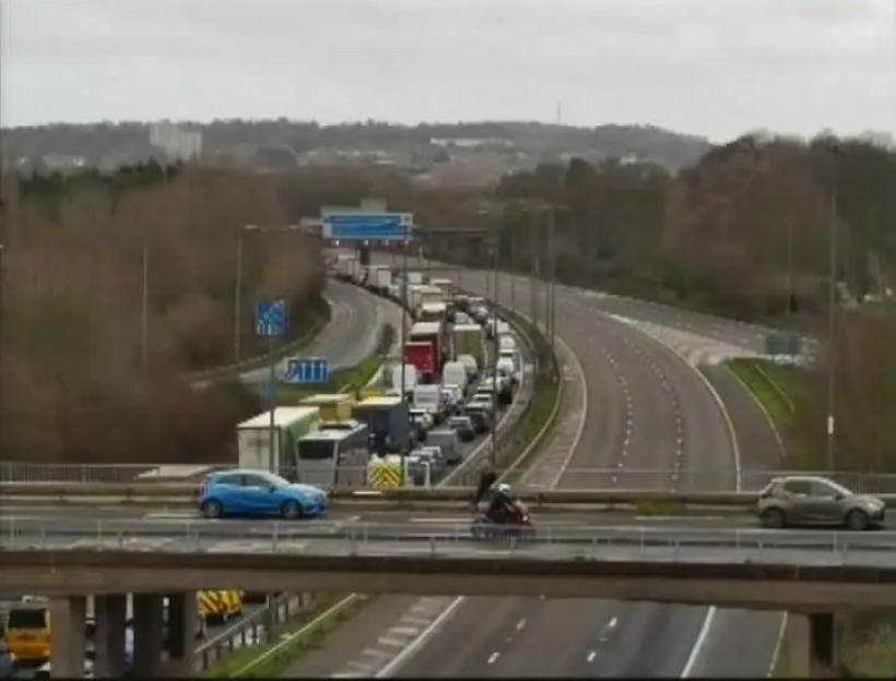 Highway camera view of heavy traffic on a multi-lane road.