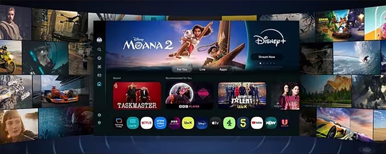 A television screen displaying a grid of app icons and recommended shows, including "Moana 2," "Taskmaster," and "Britain's Got Talent," surrounded by other video content on a curved wall of screens.