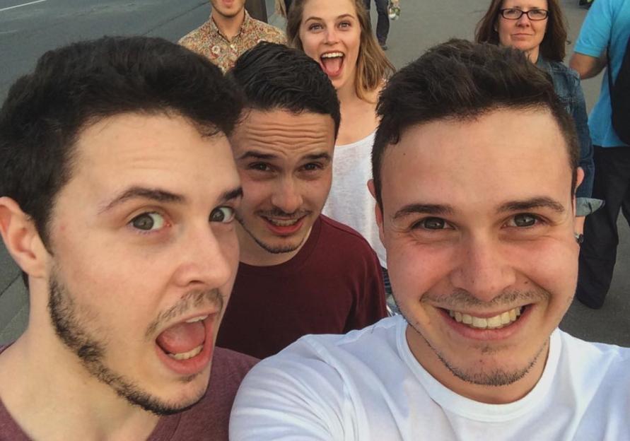 The triplets Quentin B Meloff, Andrew A Meloff, and Joel C Meloff pose for a selfie with Quentin and Andrew making wide-eyed open-mouthed expressions and Joel smiling.