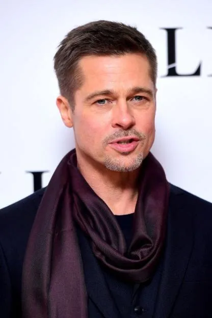 Actor Brad Pitt wearing a dark scarf.