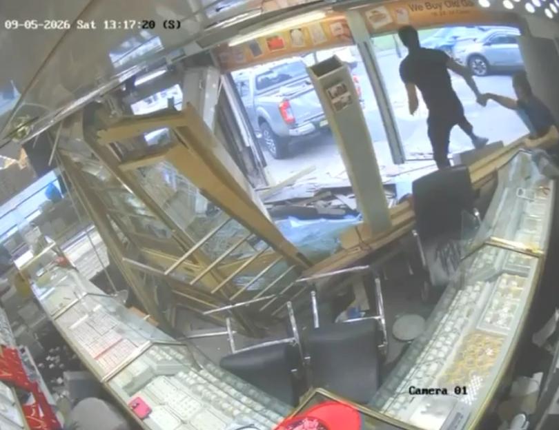CCTV footage of a 4x4 crashing into a jeweler's shop, with two people escaping.