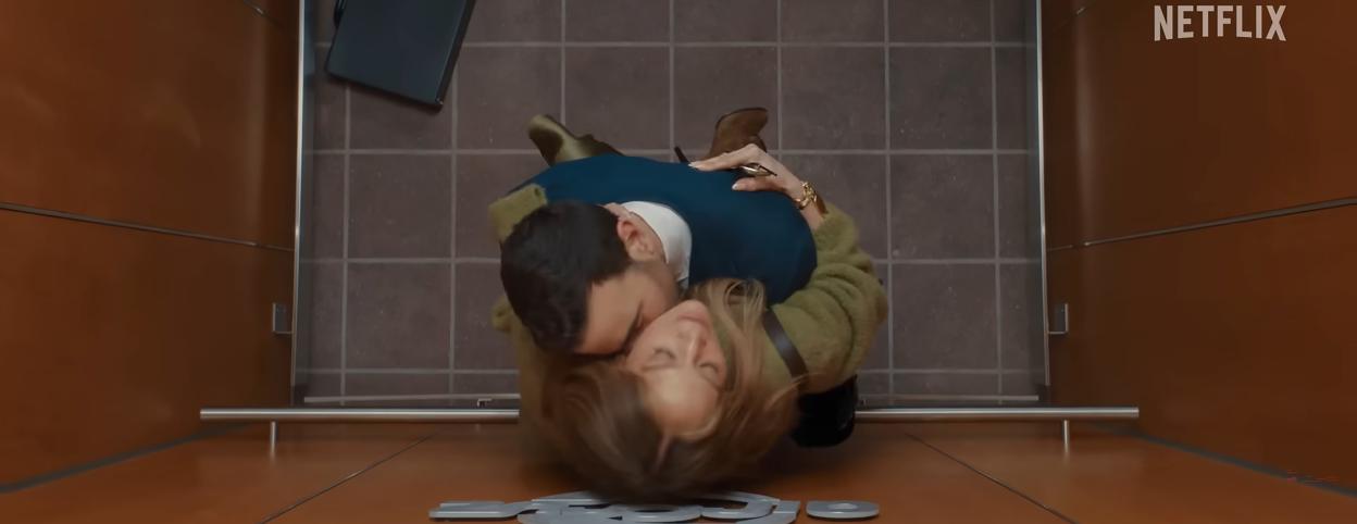 Jennifer Lopez and Brett Goldstein embrace passionately in an elevator.