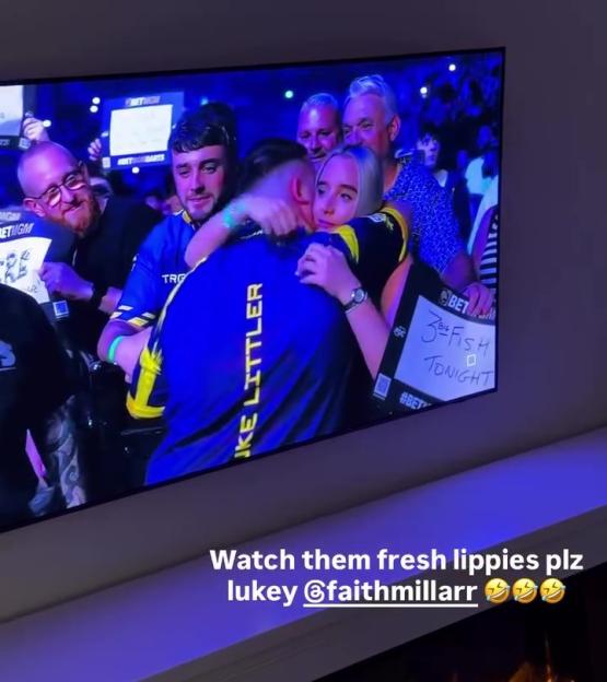 A darts player in a blue and yellow jersey embracing a woman on a TV screen, with the caption "Watch them fresh lippies plz lukey @faithmillarr" overlaid.