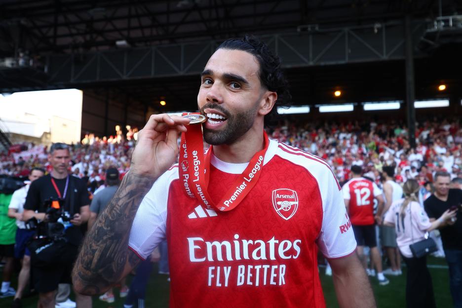 David Raya of Arsenal biting his Premier League medal.