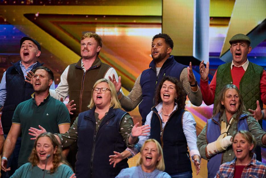 Jeremy Clarkson and a group of local people singing outside the Farmers Dog Pub.
