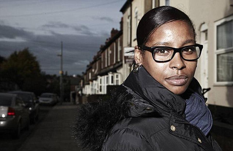 Sherrell Dillion in a black coat and glasses, looking at the camera.