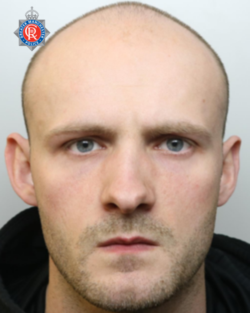 Mugshot of Elliott McBurnie, a man with a bald head and light stubble.