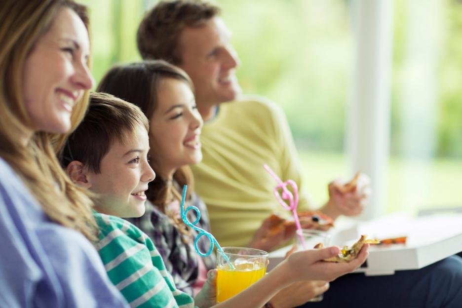 Family watching television in living room.