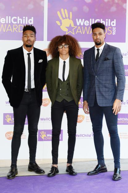 Jordan Banjo, Perri Kiely, and Ashley Banjo of Diversity on the red carpet at the WellChild Awards.