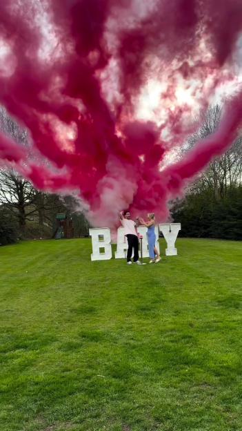 Gaz Beadle and Maia revealing the gender of their baby with pink smoke and "BABY" letters.