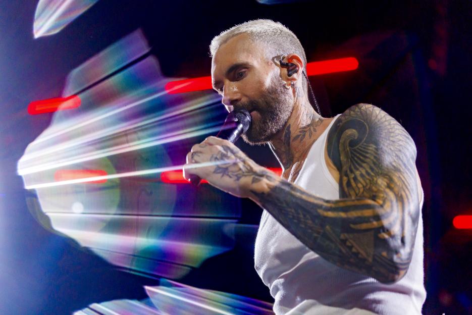 Adam Levine singing into a microphone at the 2025 iHeartRadio Music Festival.