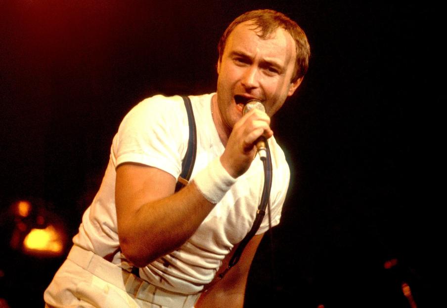 Musician Phil Collins of Genesis performing onstage.