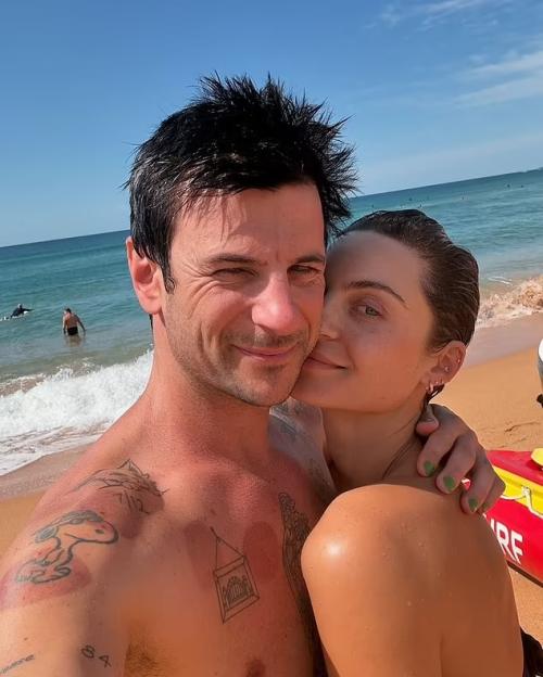 Domenica Calarco and Jarod Bogunovich smiling on a beach.