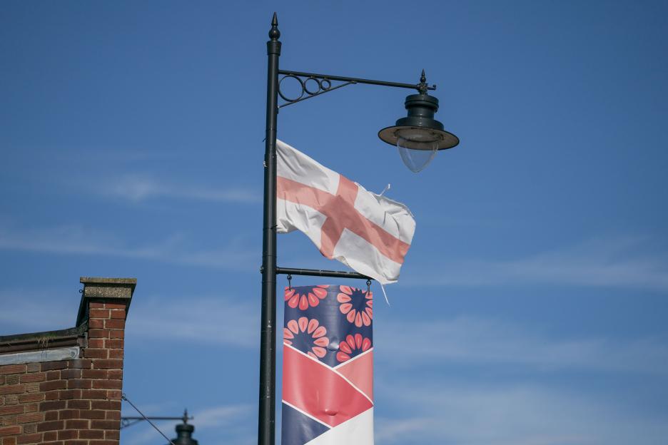 England flag and patterned banner on a lamppost.
