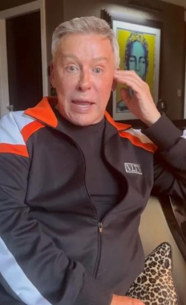 Royston Blythe wearing a black, orange, and white tracksuit.