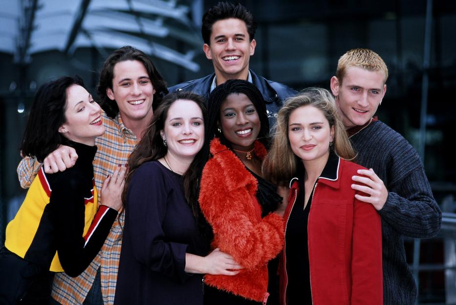 The cast of Hollyoaks, including Lisa Williamson, Nick Pickard, Brett O'Brien, Jeremy Edwards, Yasmin Bannerman, Shebah Ronay and Will Mellor, posing together.