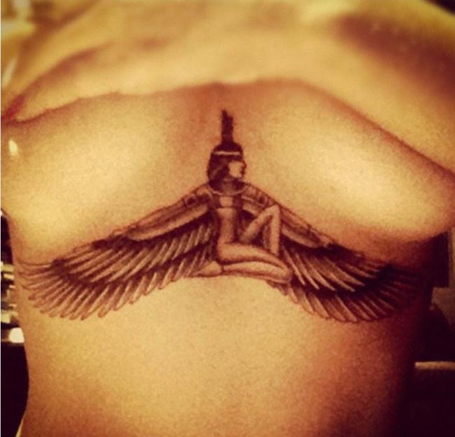 Rihanna's tattoo of the goddess Isis with wings spread under her breasts.