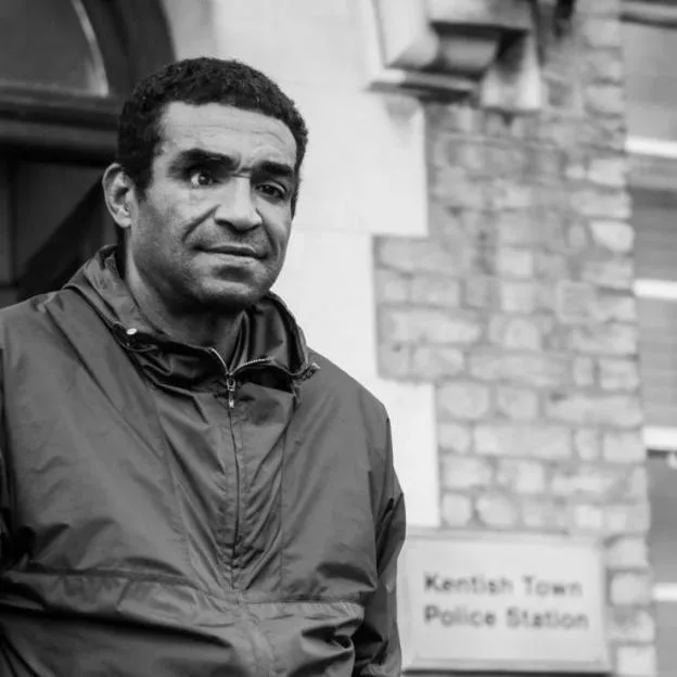 Black and white photo of Marvin Herbert outside Kentish Town Police Station.
