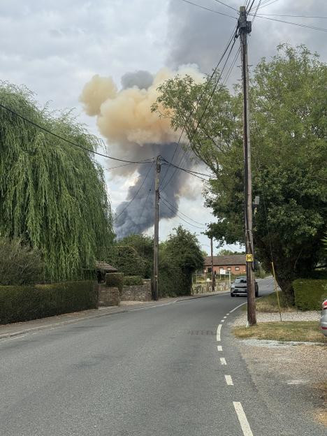 Large clouds of smoke from an explosion seen from a rural road in East Hanningfield Essex.