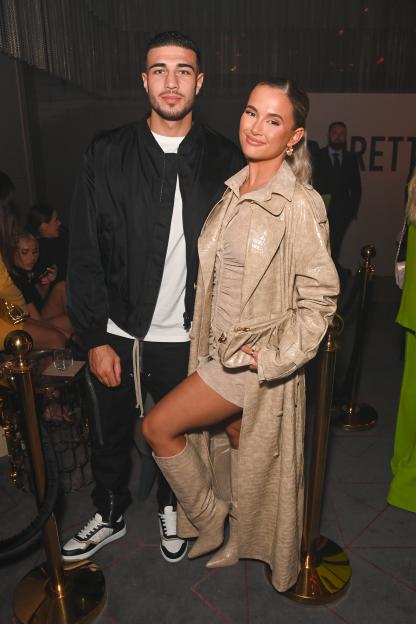 Tommy Fury and Molly-Mae Hague posing at a PrettyLittleThing event.