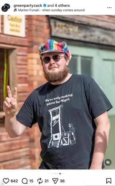 A man wearing a black t-shirt with a guillotine graphic and the text "We're only making plans for Nigel."