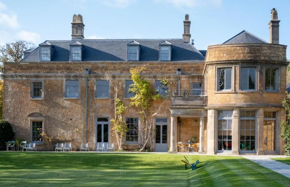 Historic Hadspen House, now The Newt in Somerset, viewed from the gardens with a croquet lawn in the foreground.