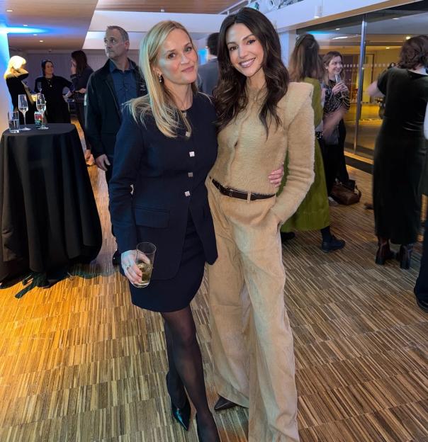 Reese Witherspoon and Michelle Keegan smiling while posing for a photo.